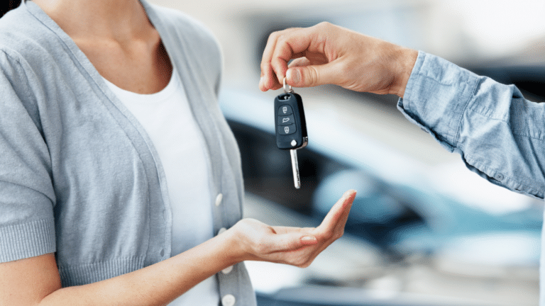 Person handing over car keys to a buyer